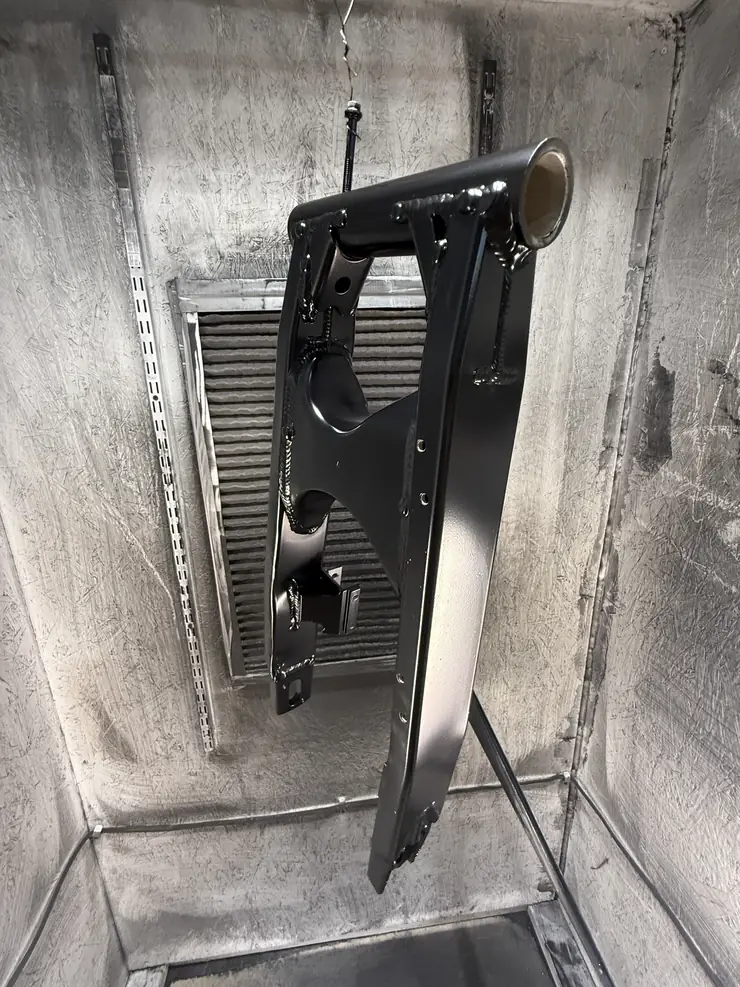 Swingarm coated gloss black, hanging in the booth