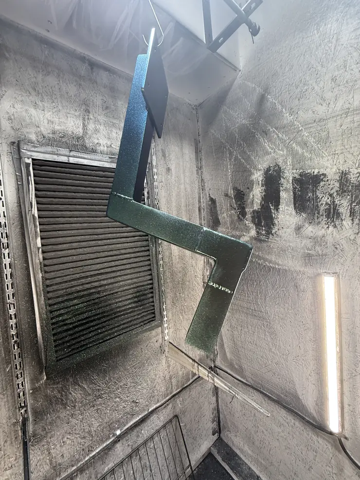 Fabricated steel bracket in metallic green